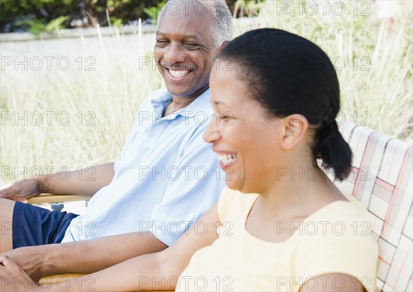 Black couple laughing outdoors together