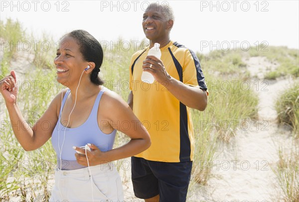 Black couple exercising on beach