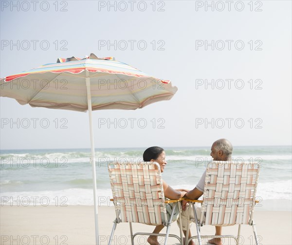 Black couple enjoying beach together