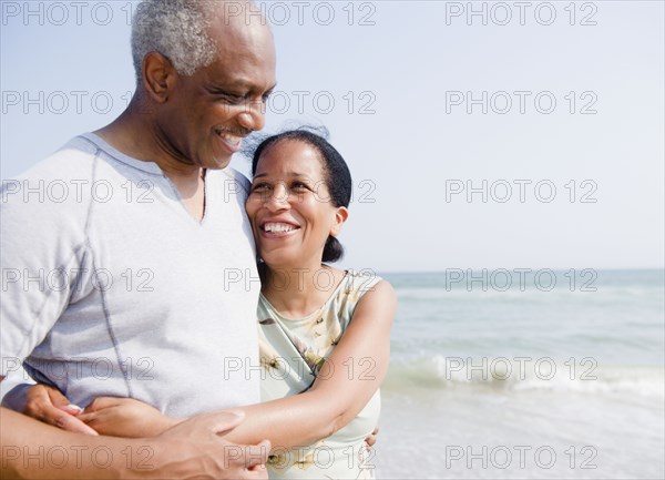 Black couple enjoying beach together