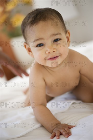 Mixed race baby crawling