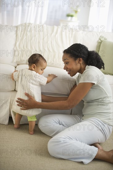 Mixed race woman playing with baby