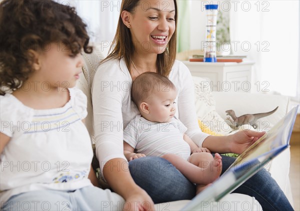 Mother reading daughters storybook