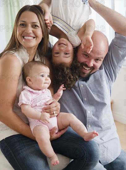 Mother and father playing with daughters