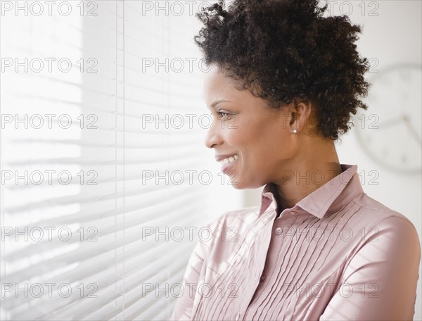 Black businesswoman looking out window