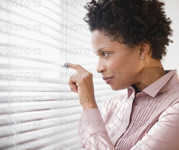 Black businesswoman looking out window