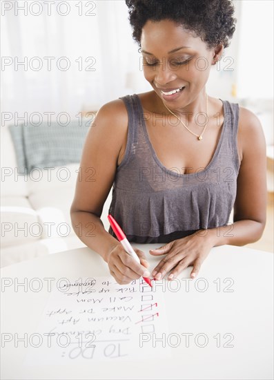 Black woman checking off to do list