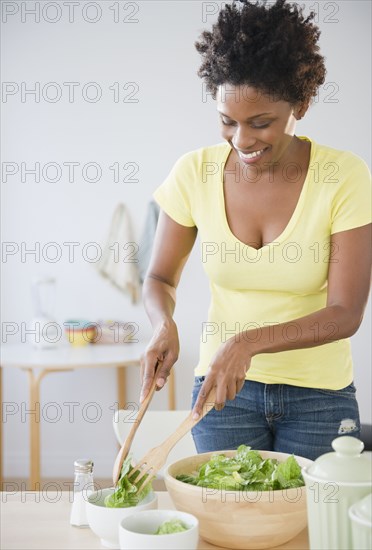 Black woman serving salad