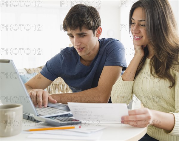 Couple paying bills together online