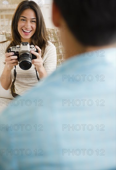 Woman taking photograph of boyfriend