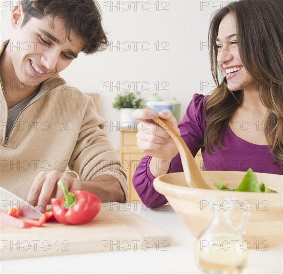 Couple preparing salad together