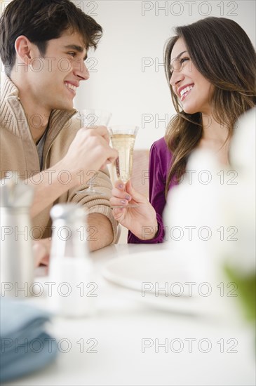 Smiling couple toasting with Champagne