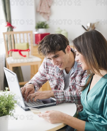 Couple shopping online with credit card