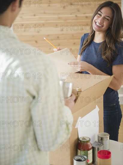 Couple packing boxes together