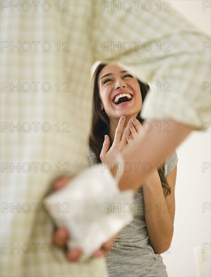 Husband giving gift to laughing wife