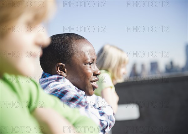 Children looking over rooftop railing