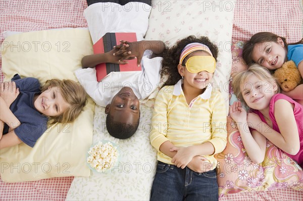 Children having slumber party together