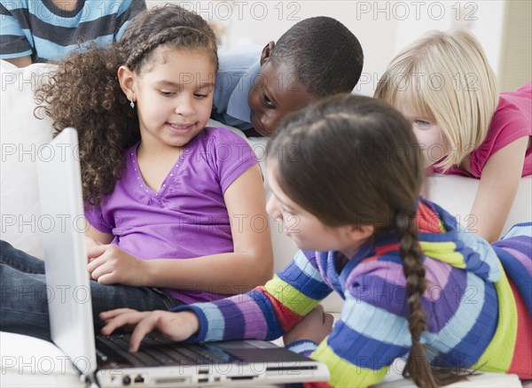 Friends using laptop together