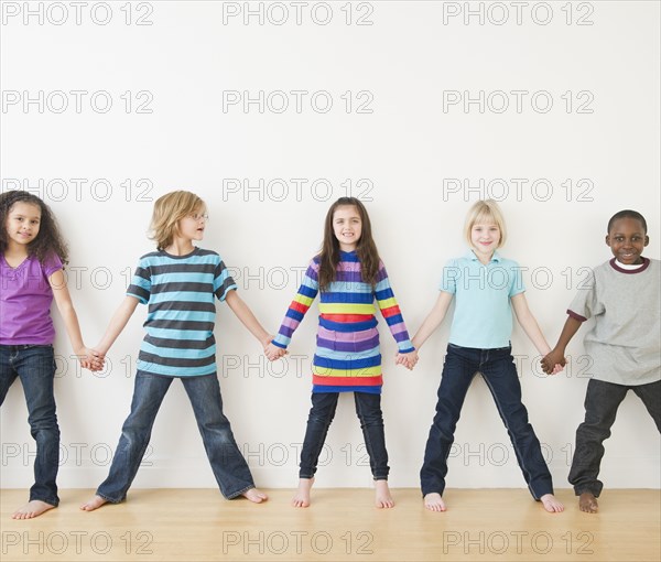 Friends holding hands in a row