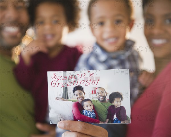 Black family holding Season's Greetings photograph