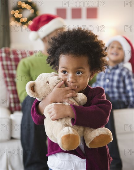 Black girl hugging teddy bear