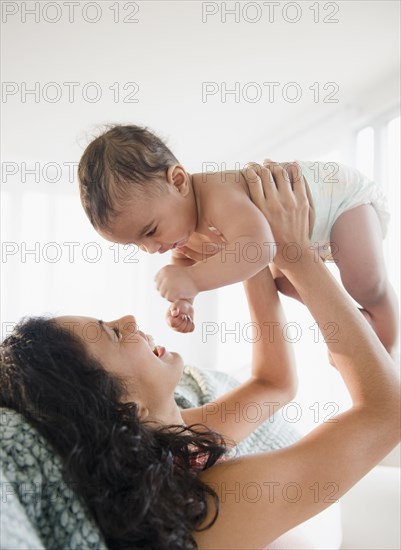 Mother lifting baby boy