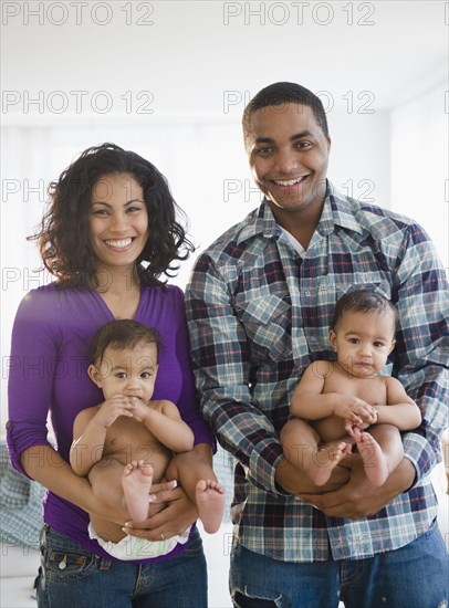 Parents holding twin baby boys