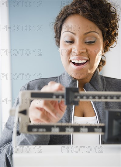 African American woman weighing herself