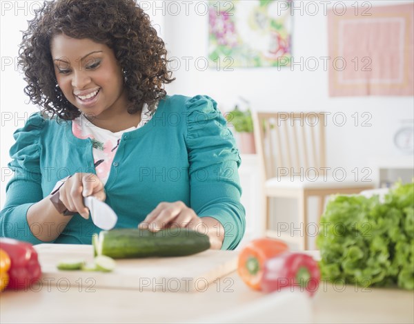 African American woman slicing vegetables