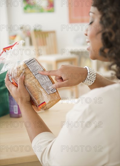 African American woman looking at loaf of bread