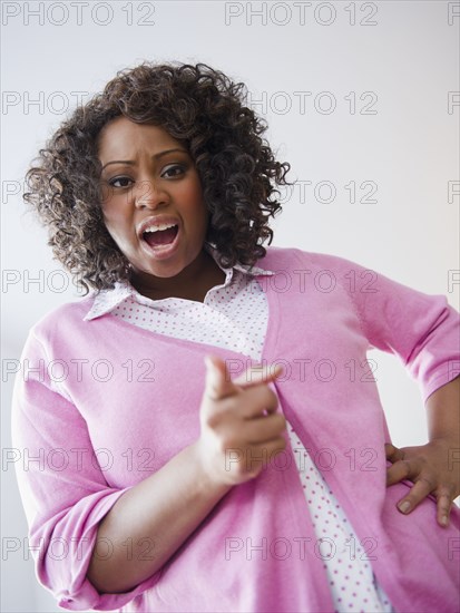 African American woman screaming and pointing her finger