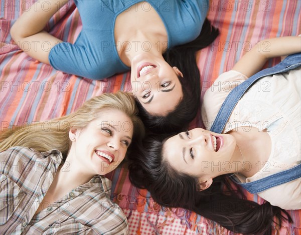 Friends laying on bed together