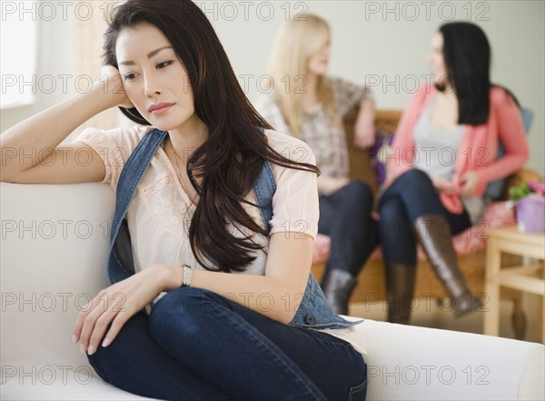 Sad woman isolated from friends