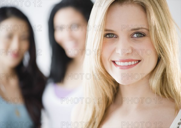 Smiling Caucasian woman standing with friends