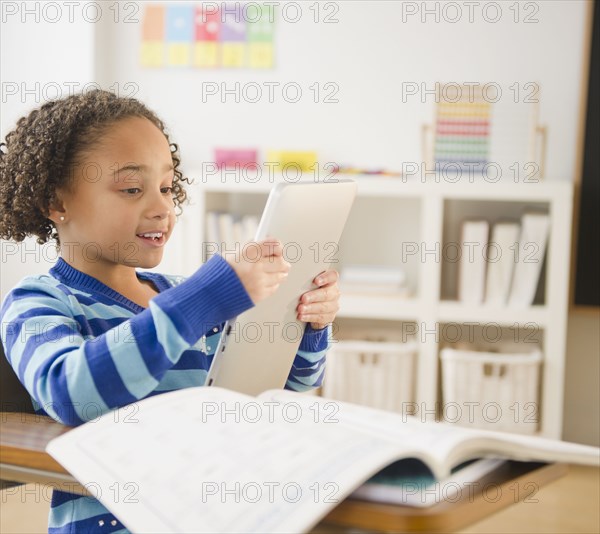 African American girl looking at digital tablet