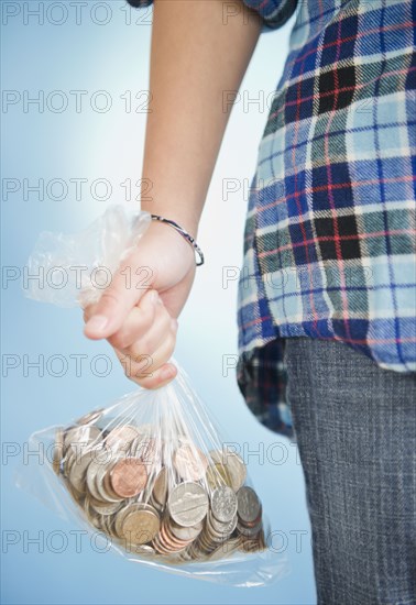 African American girl holding sack of coins