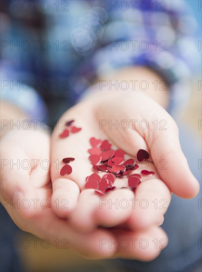African American girl holding handful of hearts