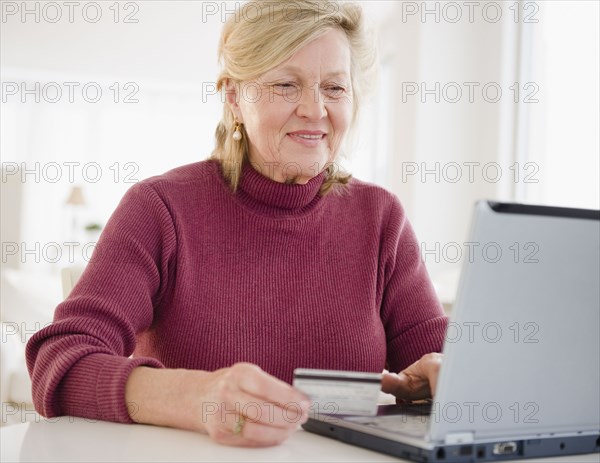 Caucasian woman shopping online with credit card