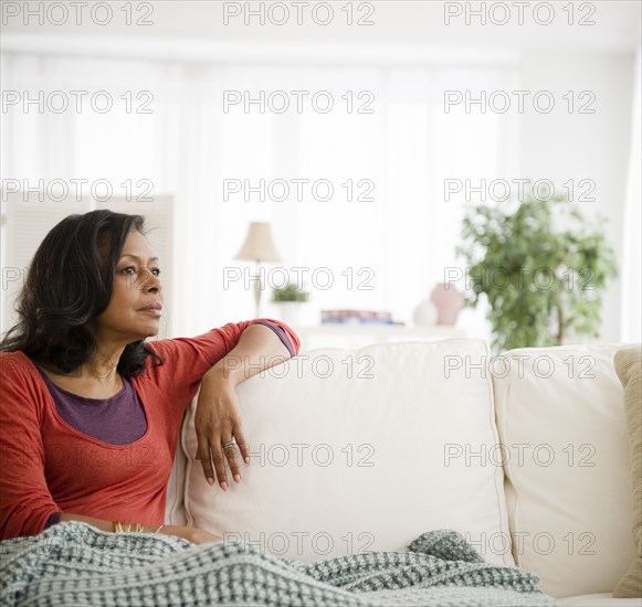 Mixed race woman laying on sofa