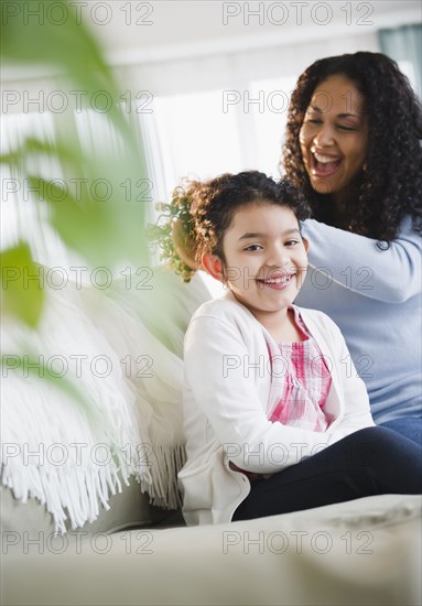 Mother brushing daughter's hair