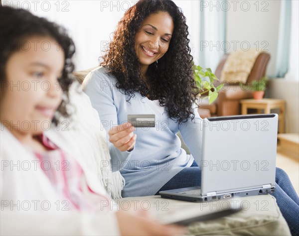 Mixed race woman shopping online with credit card