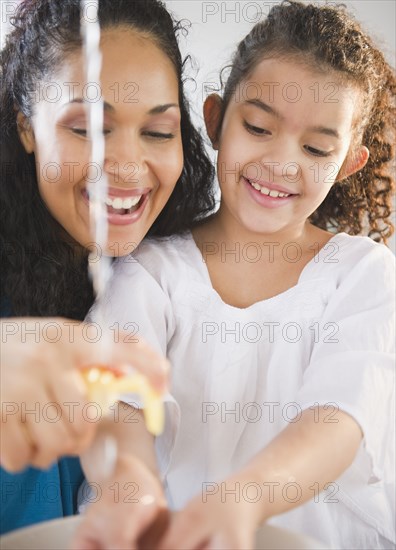 Mother helping daughter washer her hands