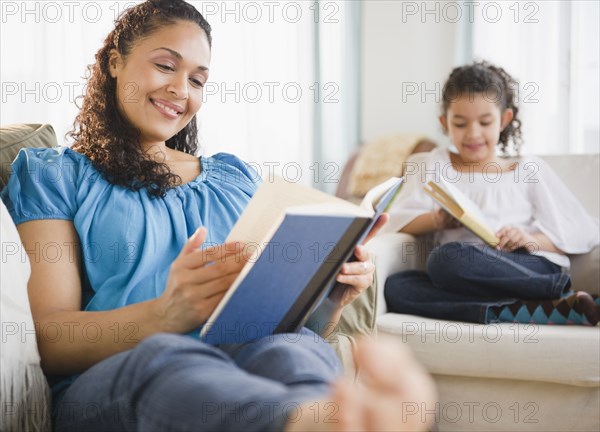 Mother and daughter reading books