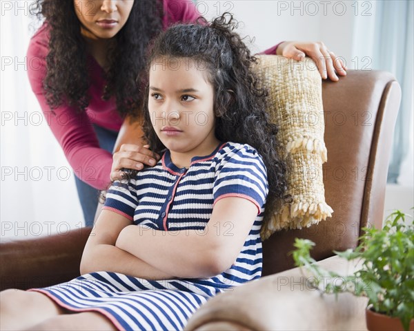 Mother comforting stubborn daughter