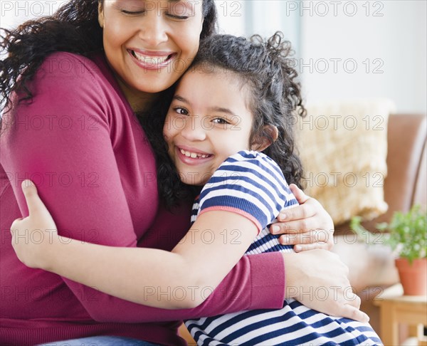 Mother and daughter hugging