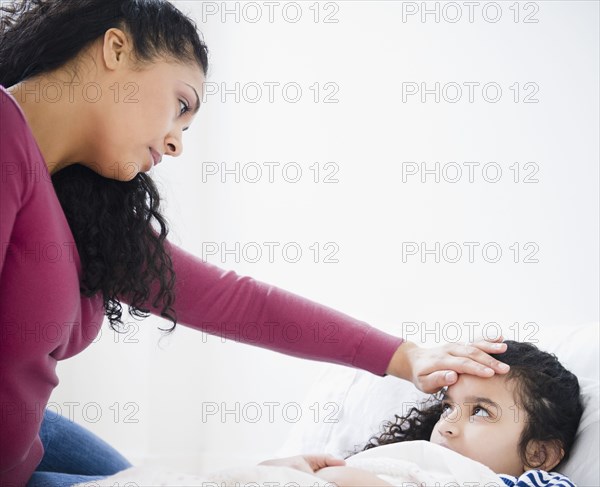 Mother checking daughter's fever