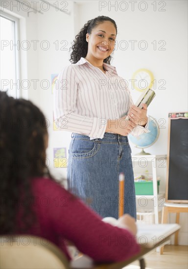 Mixed race teacher smiling in classroom