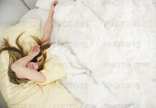 Caucasian teenage girl sleeping in bed