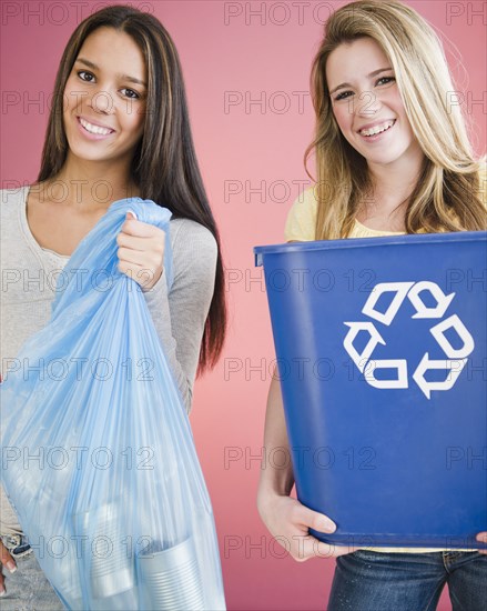 Teenage girls carrying recycling