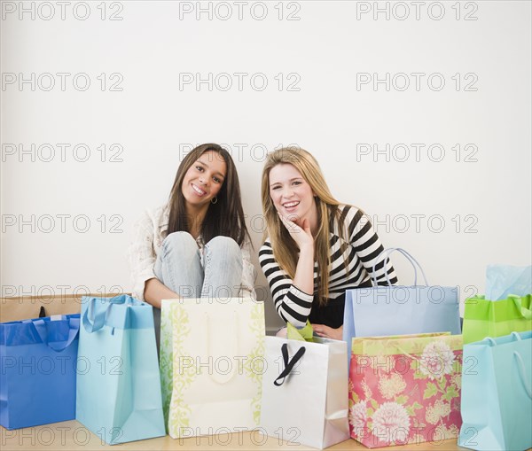 Teenage girls sitting with shopping bags